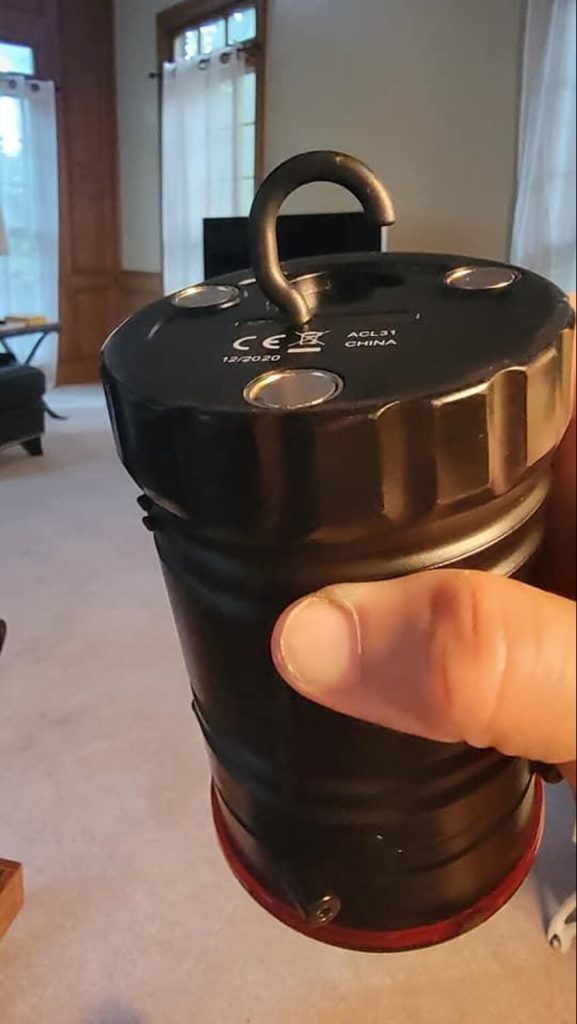 Close-up of the hook pulled out, which would allow you to hang it from something. The three magnets are also visible.