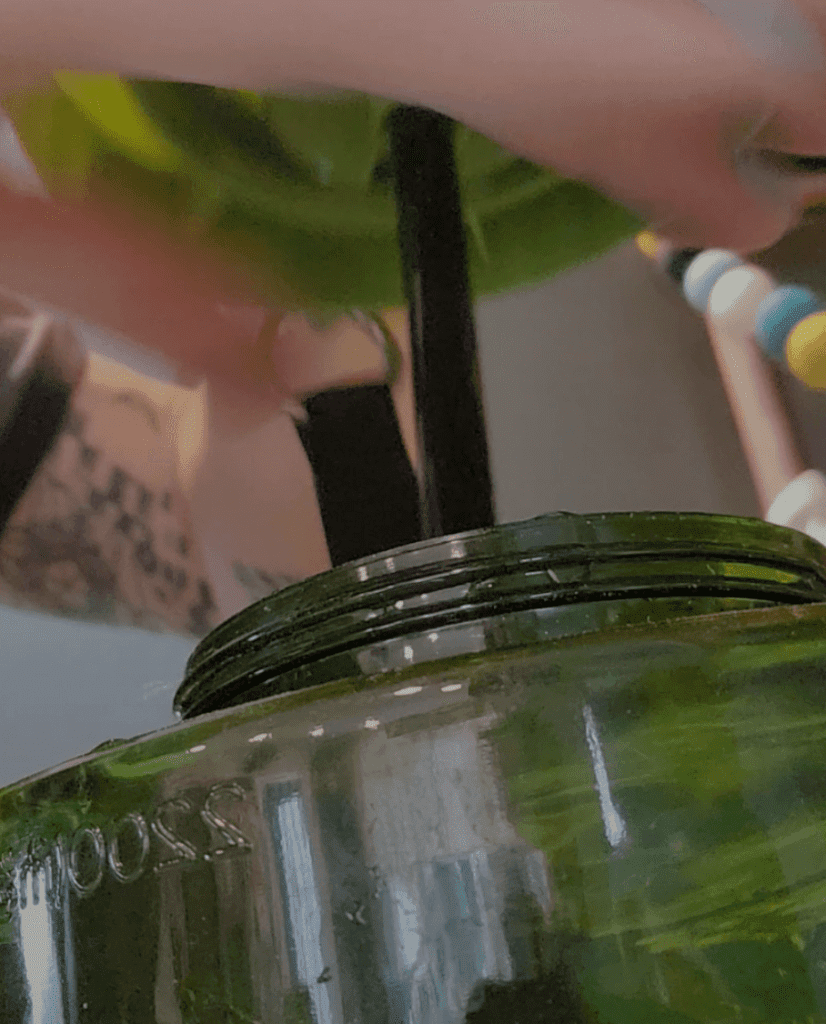A close up of the lid being removed from the dispenser