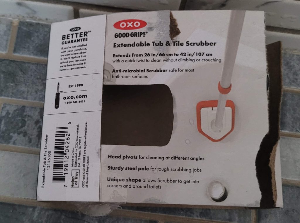 Back of the packaging with details about the length of the extender, the anti-microbial scrubber, pivoting head, steel pole, and unique shape.