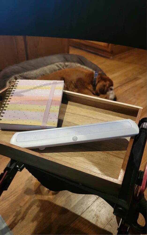 Motion sensor light strip sitting on a wooden tray turned off