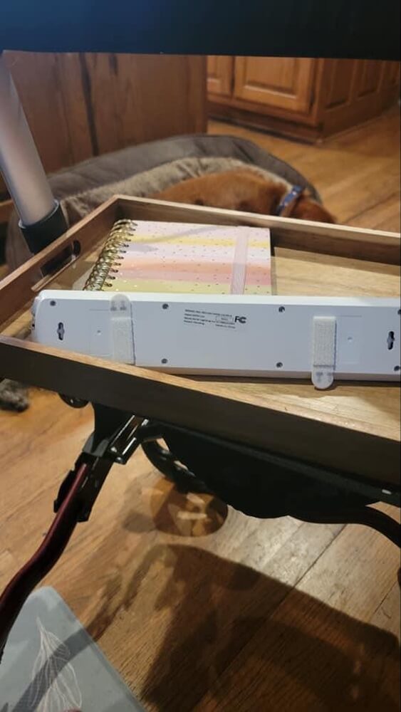 Back of the motion sensor light strip, showing the adhesive velcro pieces that would allow you to hang it.