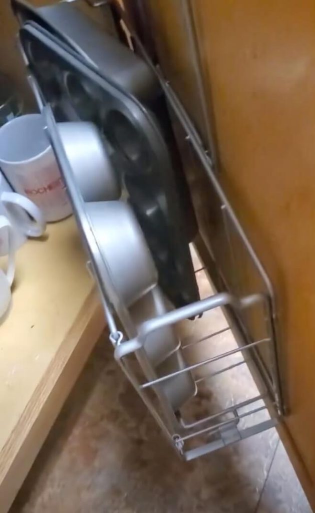 Organizer holding muffin tins.