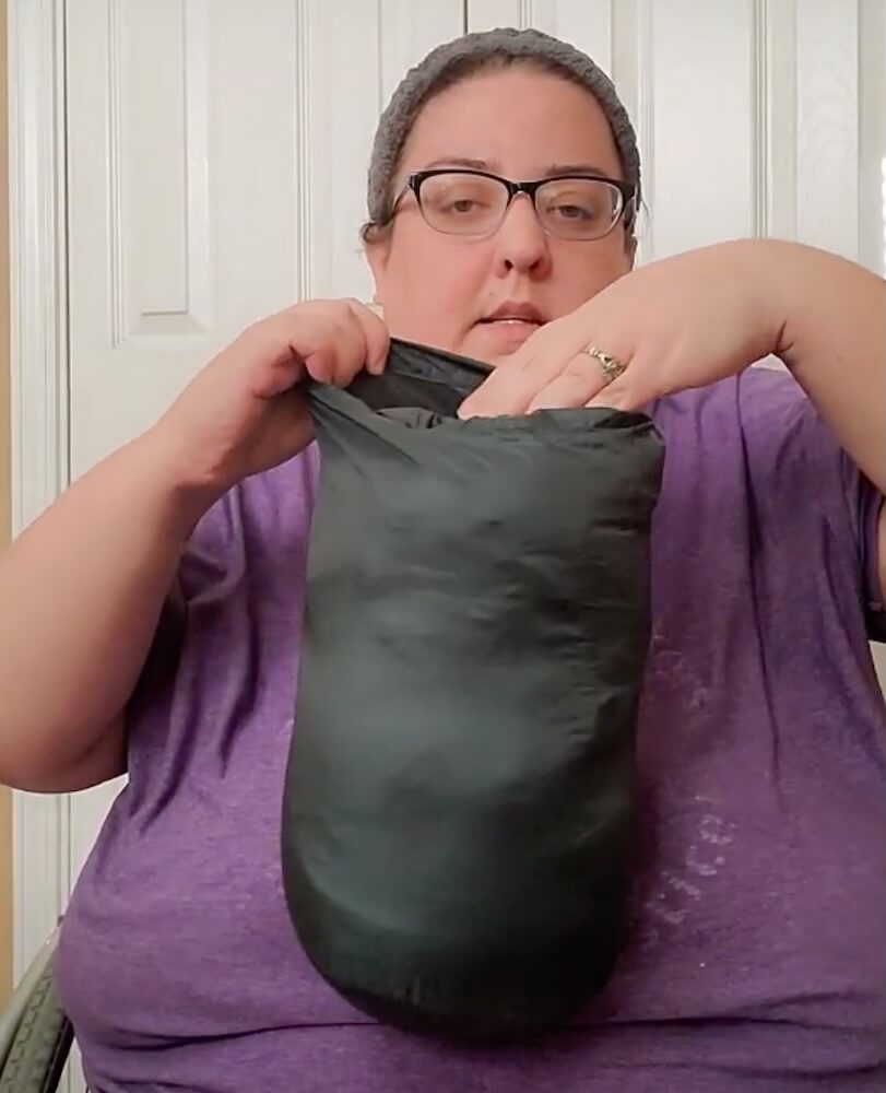 Ericka showing how the jacket can be stuffed into a carrying case