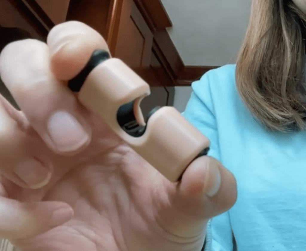 A person is pushing the bread bag clip open