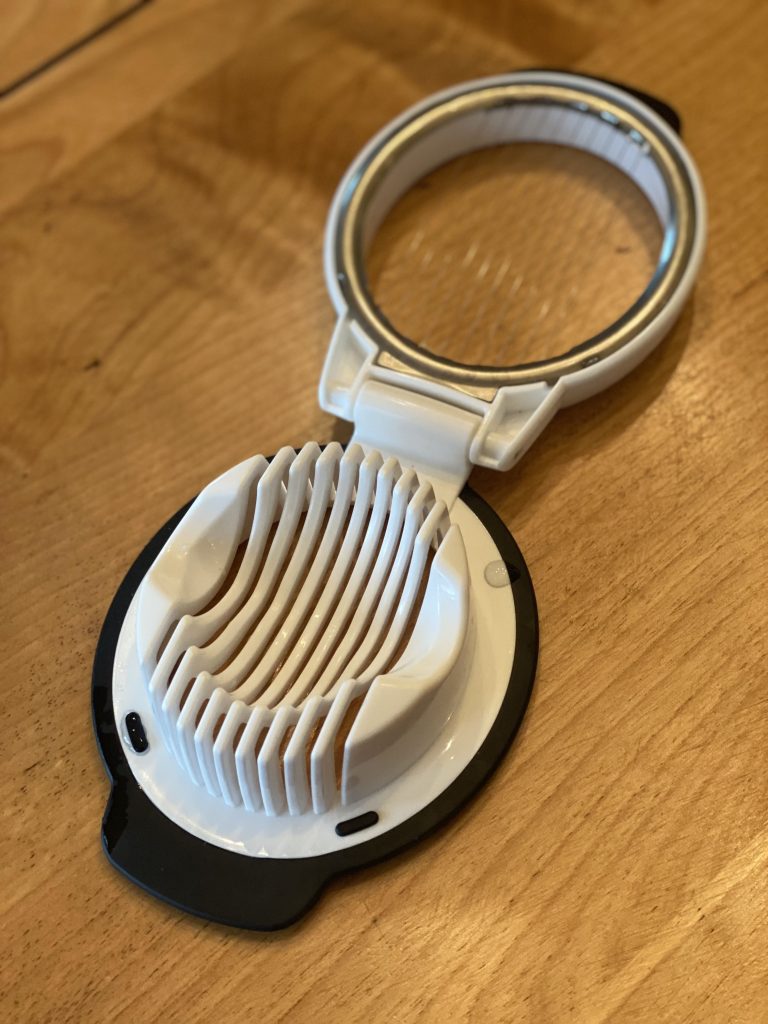 White egg slicer with black base in an open position
