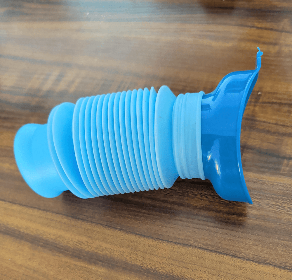 A blue plastic portable urinal